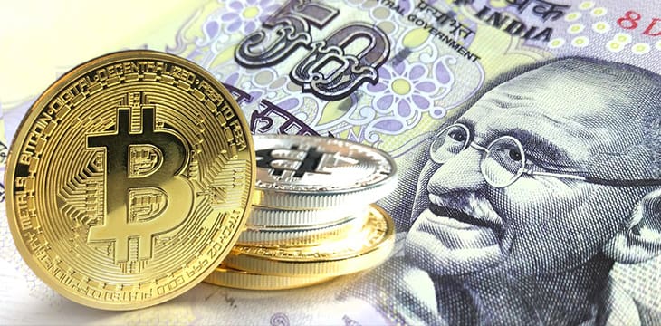 Bitcoin coins on Indian rupee banknote, Cryptocurrency concept photo