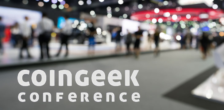 CoinGeek Conference logo with blurred event in the background