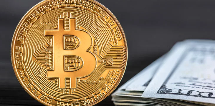 Close up image of Bitcoin and dollarbills
