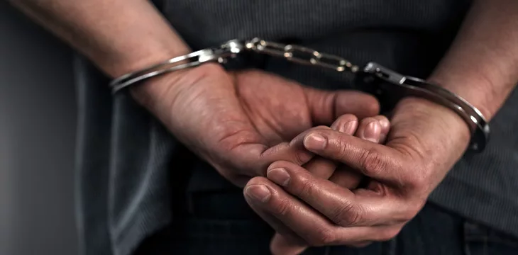 close up image of man in handcuffs. Arrest concept