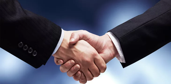 Business men shaking hands firmly