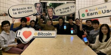 Photo of a group of people holding signs about BSV (Bitcoin SV)