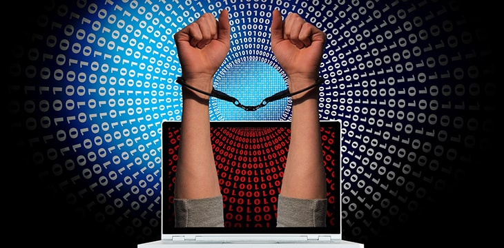handcuffed hands coming out of a laptop with numbers as background. concept of money laundering arrest