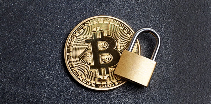 Bitcoin security concept. Gold coin with padlock