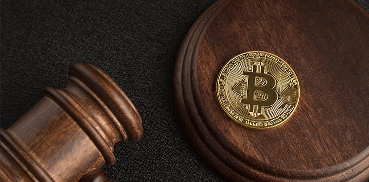 Bitcoin and judge gavel. Cryptocurrency legislation. Close up. Violation of law.