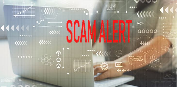 Scam alert with woman using her laptop