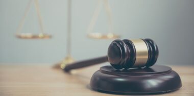 Gavel against a blurred justice scale
