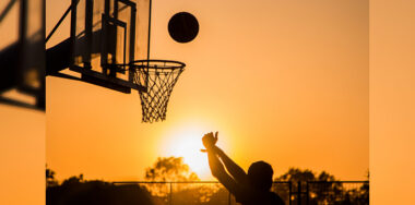 Silhouette of a person playing basketball