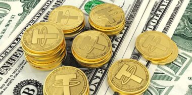 Tether. Cryptocurrency Gold coins. Cryptocurrency mining. Coins on the background of the dollar.