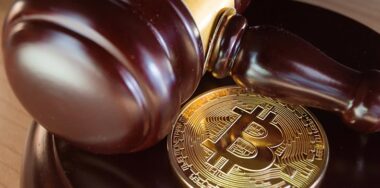 BTC cryptocurrency coin and judge gavel on a desk