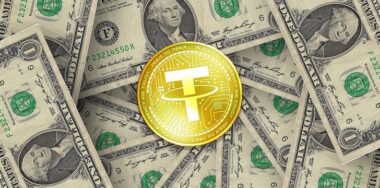 Tether crypto coin over a stock of bills