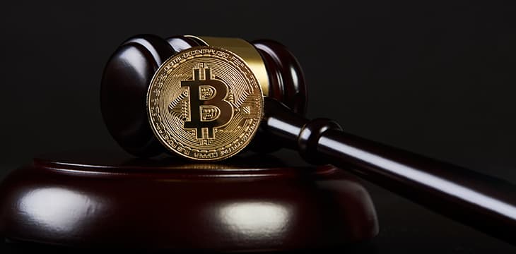 Law Gavel and golden bitcoin cryptocurrency money symbol on dark background with copyspace. Crypto currency law theme. Business Internet Concept