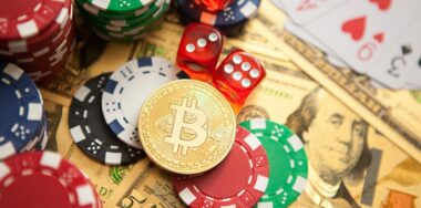 Colorful casino chips, dollars, bitcoins and red dice