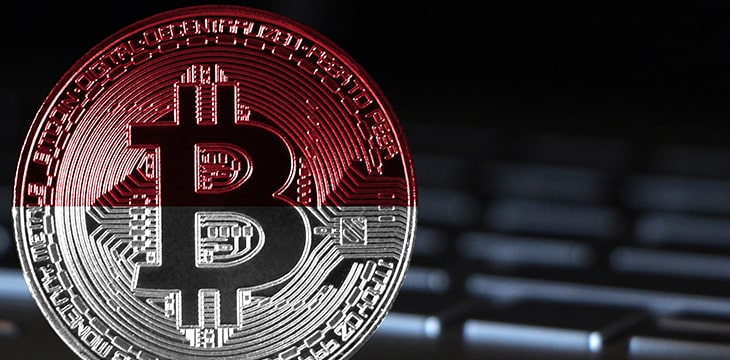 Bitcoin close-up on keyboard background, the flag of Indonesia is shown on bitcoin.