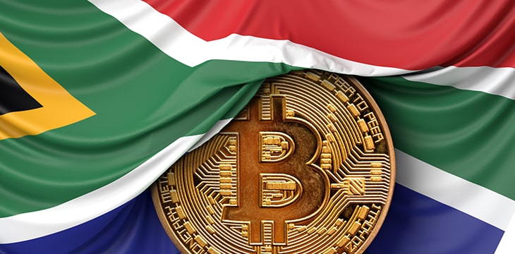 South Africa flag draped over a bitcoin cryptocurrency coin