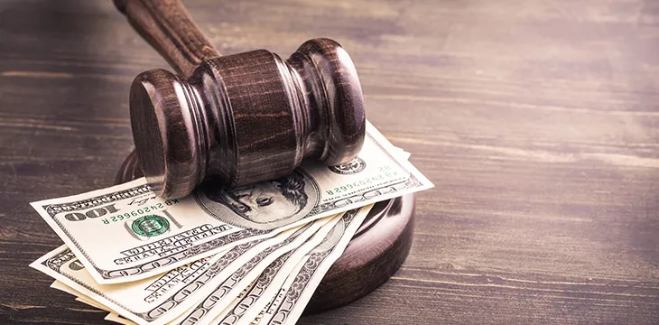 Gavel and dollars banknotes on table