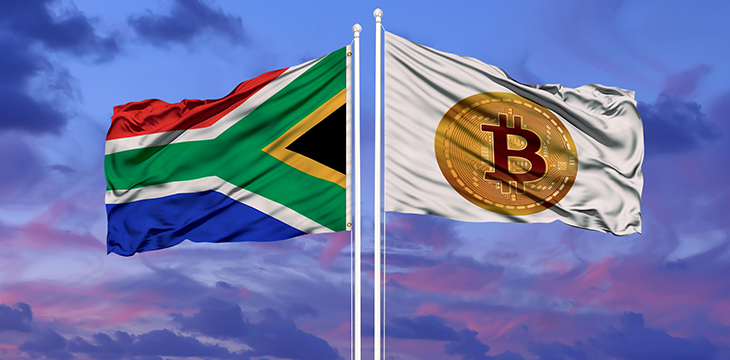 The flag of South Africa and the Bitcoin flag are waving over the blue sky