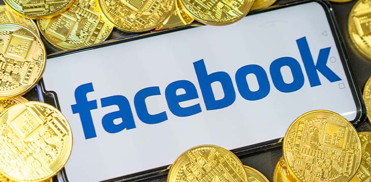 Facebook on a phone screen with gold coins surrounding it