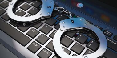 handcuffs on top of a laptop keyboard