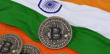 bitcoin with flag of India behind it