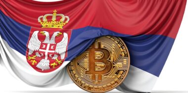 Serbia flag draped over a bitcoin cryptocurrency coin