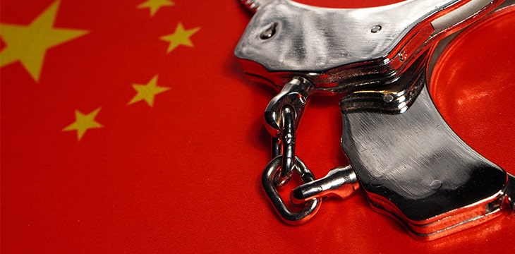 China flag with metal handcuff on top