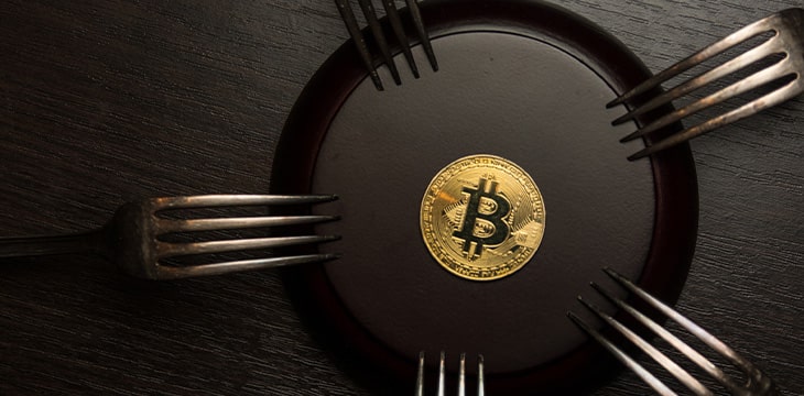 Golden bitcoin with silver forks