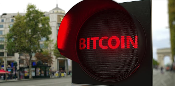 BITCOIN text on red traffic light signal.