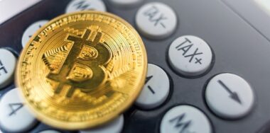 Bitcoin coin on a calculator