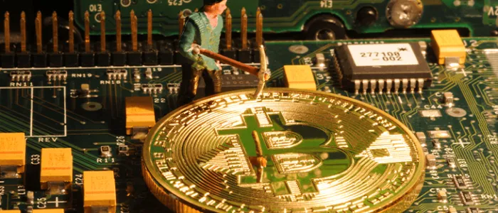 Aminer toy on a motherboard with bitcoin coins