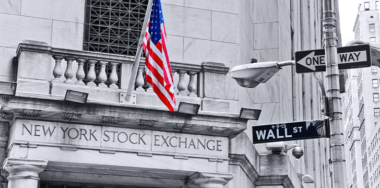BW image of NYSE branch wall street with colored US flag