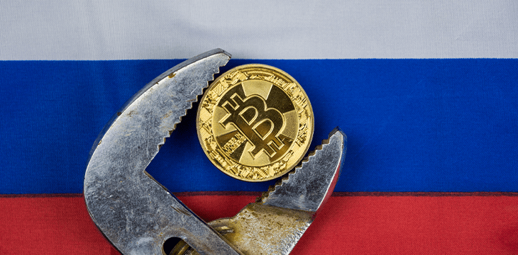 Bitcoin squeezed in vice with russian flag as bg