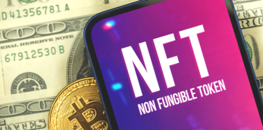 concept nft non fungible token in mobile screen lying in dollars