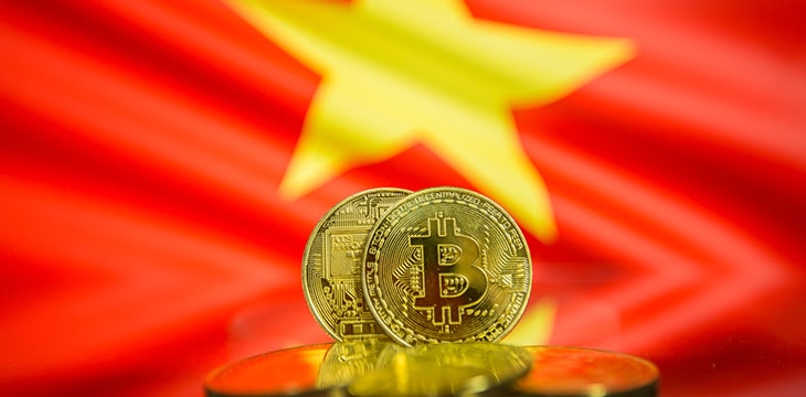 Bitcoin gold coin and defocused flag of Vietnam