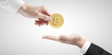 Hand giving bitcoin