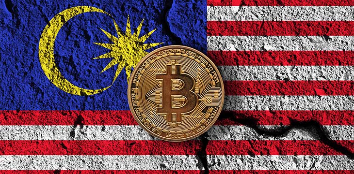 Bitcoin crypto currency coin with cracked Malaysia flag