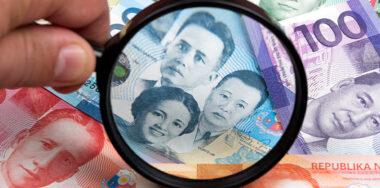 Philippine peso in a magnifying glass