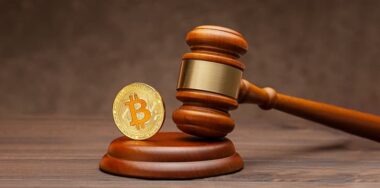 Bitcoin and judge gavel on wooden brown background