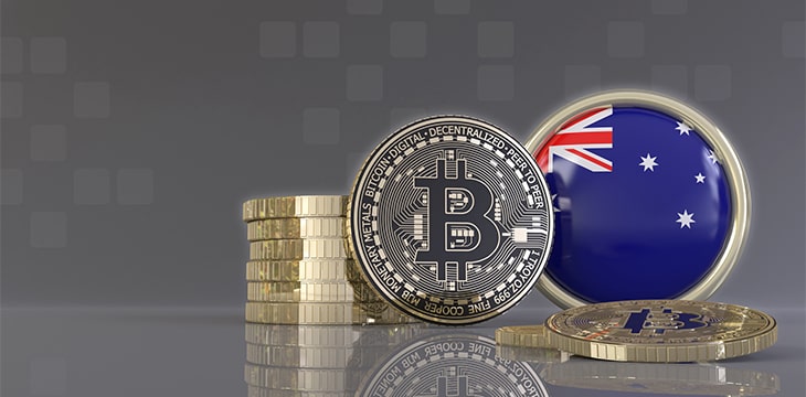 metallic Bitcoins in front of badge with the flag of Australia