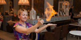 A lady doing fire trick on her palm