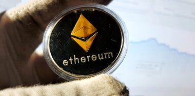 Ethereum silver metal coin in capsule and gold rhombus symbol of cryptocurrency.