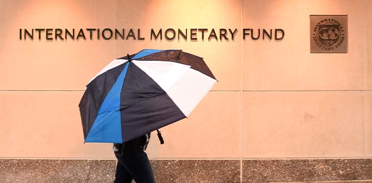 Washington, DC - June 04, 2018: Pedestrian with an umbrella near International Monetary Fund, IMF Headquarters 2 Building (HQ2) in DC.