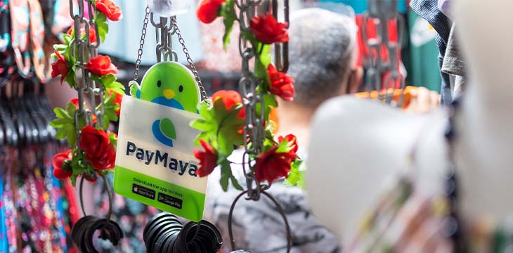 PayMaya sign hangs on a small boutique at a market. E-wallet payment option.