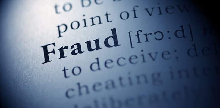 Photo of a dictionary page focused on the word fraud