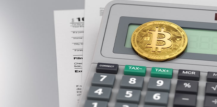 Calculator with documents and Bitcoin on table