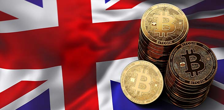 Stack of Bitcoin coins on UK flag. Situation of Bitcoin and other cryptocurrencies in UK concept.