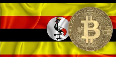 Bitcoin gold coin on Uganda flag background.