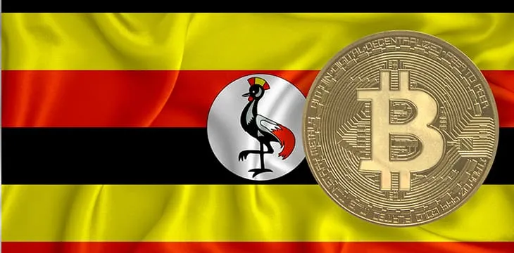 Bitcoin gold coin on Uganda flag background.