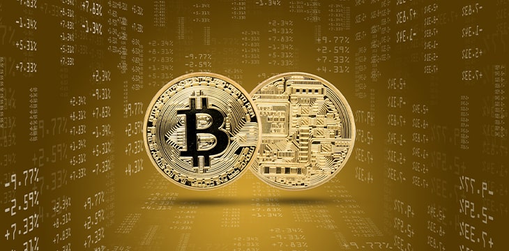 Two gold bitcoins of different sides with trading figures on background