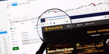Binance cryptocurrency exchange website under magnifying glass